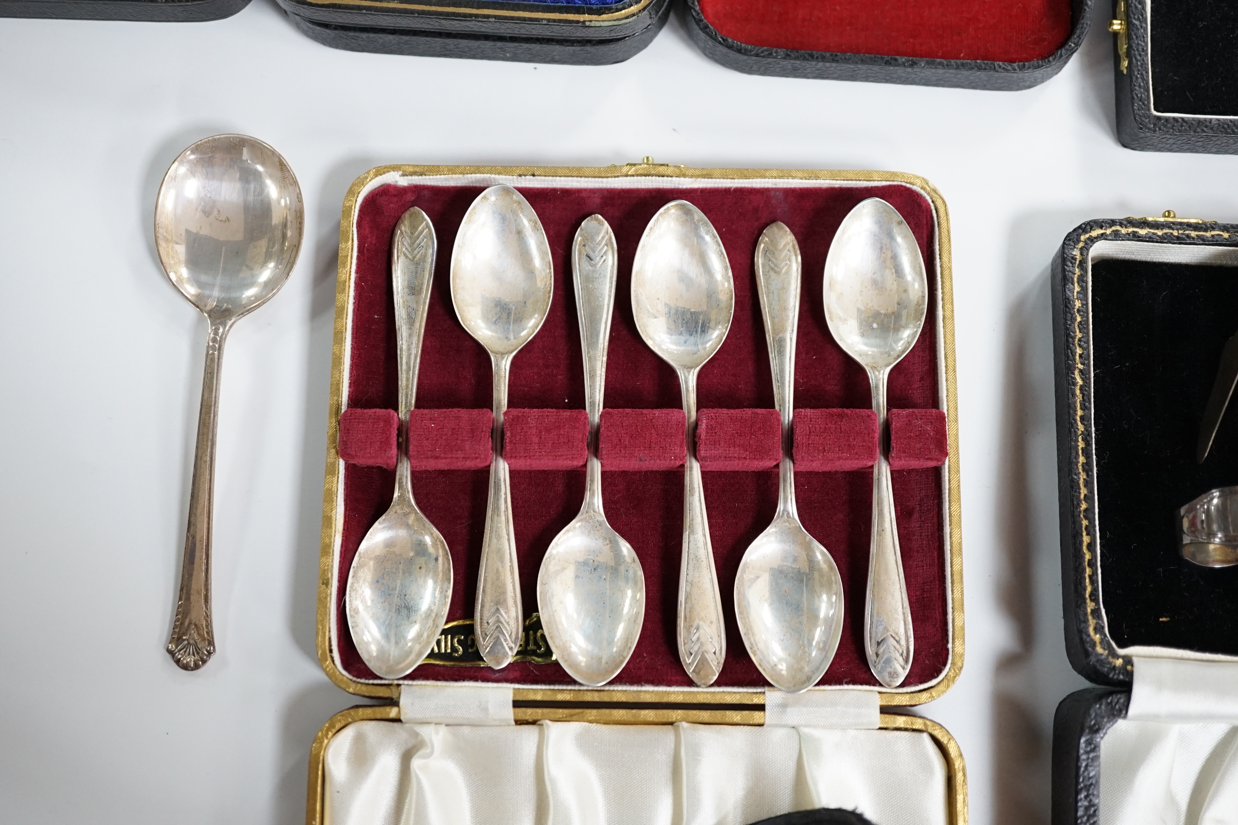 A cased set of six mid 20th century silver teaspoons, a cased silver spoon and pusher, two cased silver christening sets, a boxed silver spoon and one other incomplete cased set. Condition - poor to fair